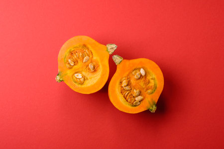 Half a raw pumpkin, a ripe orange colored butternut squash. Raw pumpkin as a food background for...