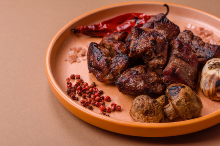 Beef, grilled meat in pieces, or kebab with sauce and vegetables. Beef in pieces as a food background for your designの写真素材