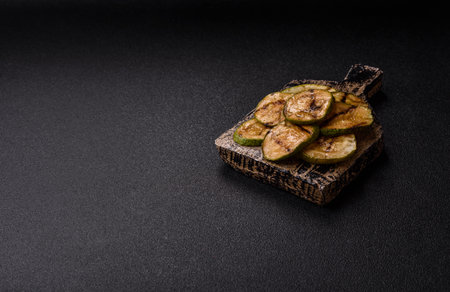 Grilled green zucchini slices, vegetarian food. Green barbecue zucchini as a food background for your designの写真素材