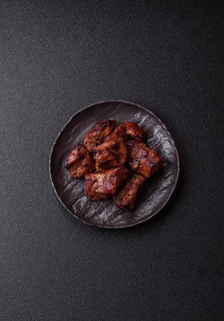 Beef, grilled meat in pieces, or kebab with sauce and vegetables. Beef in pieces as a food background for your designの写真素材