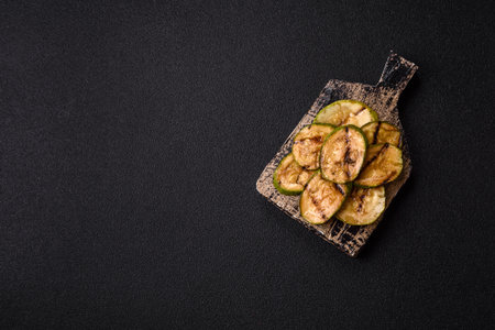 Grilled green zucchini slices, vegetarian food. Green barbecue zucchini as a food background for your designの写真素材