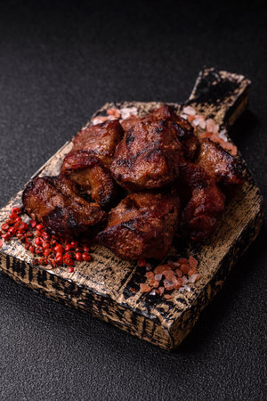 Beef, grilled meat in pieces, or kebab with sauce and vegetables. Beef in pieces as a food background for your designの写真素材