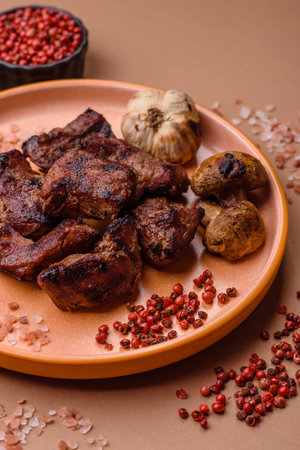 Beef, grilled meat in pieces, or kebab with sauce and vegetables. Beef in pieces as a food background for your designの写真素材