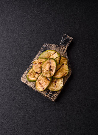 Grilled green zucchini slices, vegetarian food. Green barbecue zucchini as a food background for your designの写真素材