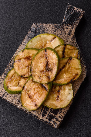 Grilled green zucchini slices, vegetarian food. Green barbecue zucchini as a food background for your designの写真素材