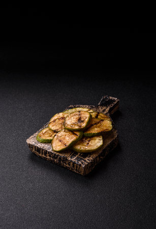 Grilled green zucchini slices, vegetarian food. Green barbecue zucchini as a food background for your designの写真素材
