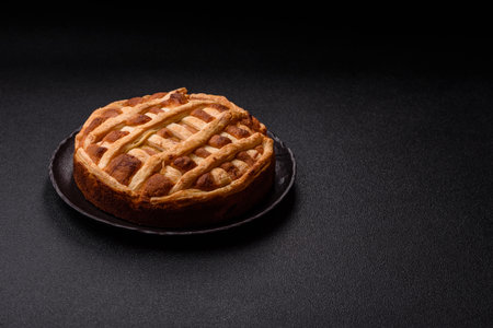 Sweet American pie with apples, pears, and cinnamon, a homemade dessert. Apple American pie as a food background for your design.の写真素材