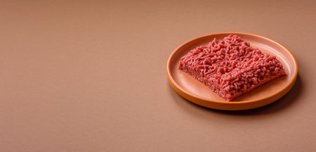 Raw ground beef for a burger or as an ingredient in a meat dish. Raw ground beef as a food background for your designの写真素材