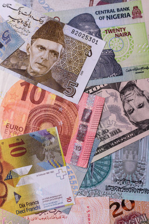 Paper money, banknotes of different countries in several denominations as a business background. Paper money and cash as a financial background for your design.の写真素材
