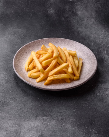 French fries are salty, crispy, and fried in oil, unhealthy takeaway food. French fries as a food...
