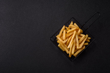 French fries are salty, crispy, and fried in oil. French fries as a food backdrop for your design.