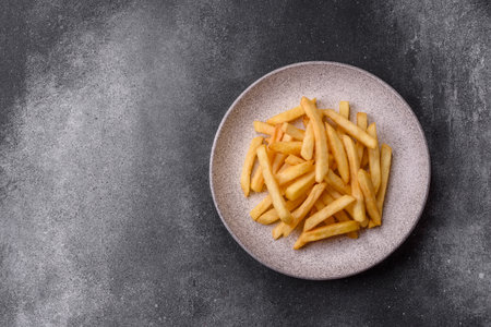 French fries are salty, crispy, and fried in oil, takeaway food. French fries as a food backdrop for your design.の写真素材
