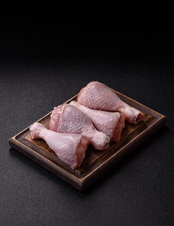 Raw chicken legs, poultry meat on the bone. Chicken legs as a food background for your designの写真素材