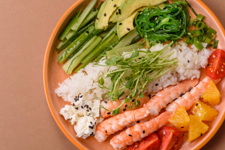 A prawn or shrimp bowl with rice, tomatoes, sauce, and vegetables, Asian food. Prawn or shrimp as a...