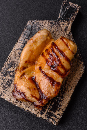 Grilled boneless chicken legs baked on the barbecue for lunch. Grilled chicken as a food background for your design.の写真素材