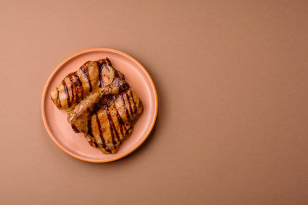 Grilled boneless chicken legs baked on the barbecue for lunch. Grilled chicken as a food background for your design.の写真素材