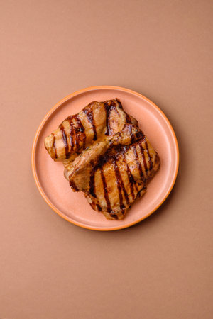 Grilled boneless chicken legs baked on the barbecue for lunch. Grilled chicken as a food background for your design.の写真素材