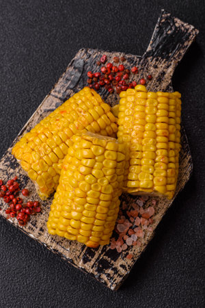 Corn cob cooked in chunks, vegetables, healthy vegetarian food. Boiled corn as a food background for...