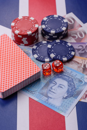 Casino game in the Great Britain, pound sterling money, chips, cards and other attributes. Gambling in casinos in the England as a background for your designの写真素材