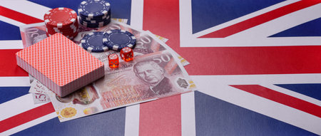 Casino game in the Great Britain, pound sterling money, chips, cards and other attributes. Gambling in casinos in the England as a background for your designの写真素材