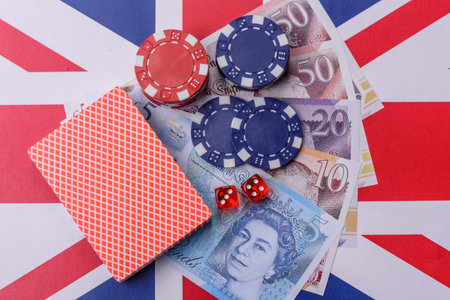 Casino game in the Great Britain, pound sterling money, chips, cards and other attributes. Gambling in casinos in the England as a background for your designの写真素材