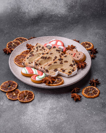 Stollen, a German Christmas pastry and dessert with fruit and marzipan, is perfect for the winter holiday table. Stollen as a food background for your designの写真素材