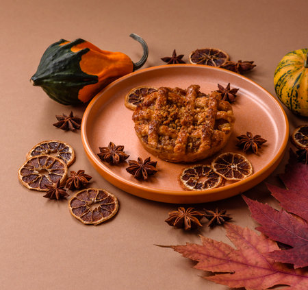 Apple or pumpkin pie or tart is a sweet American autumn treat. American apple pie as a food background for your designの写真素材