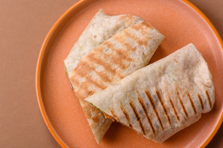 Shawarma with chicken or beef, tortilla roll, and vegetables. Shawarma with meat and vegetables as a food background for your design.の写真素材