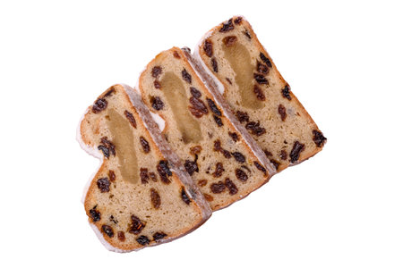 Stollen, a German Christmas pastry and dessert with fruit and marzipan, is perfect for the winter holiday table. Stollen as a food background for your designの写真素材