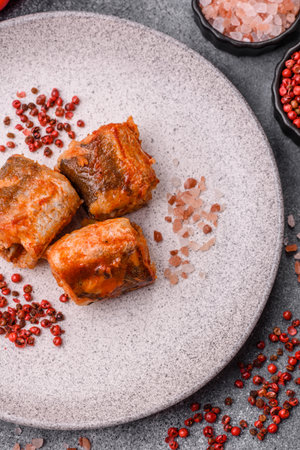 Hake fish cooked in pieces in tomato sauce, stew with peppers and carrots. Hake fish in tomato sauce as a background for your design.の写真素材