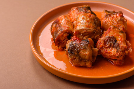 Hake fish cooked in pieces in tomato sauce, stew with peppers and carrots. Hake fish in tomato sauce...