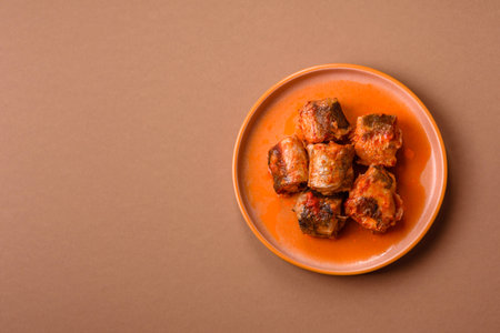 Hake fish cooked in pieces in tomato sauce, stew with peppers and carrots. Hake fish in tomato sauce as a food background for your design.の写真素材