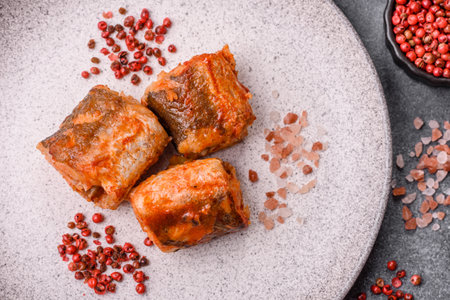 Hake fish cooked in pieces in tomato sauce, stew with peppers and carrots.の写真素材