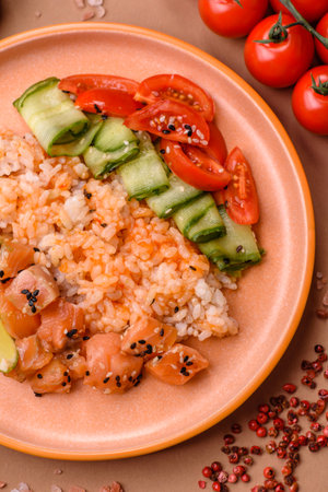 A food bowl with salmon, rice, avocado, tomatoes, and cucumbers.の写真素材