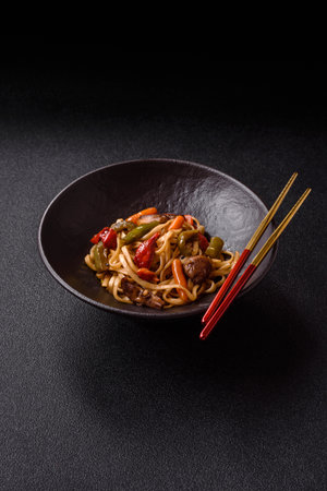 Asian food, noodles with vegetables, vegetarian dish with spicy sauce. Noodles with vegetables as a food background for your designの写真素材