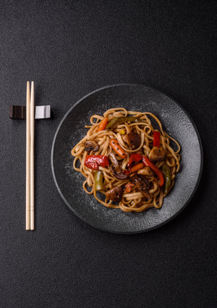 Asian food, noodles with vegetables, vegetarian dish with spicy sauce. Noodles with vegetables as a food background for your designの写真素材