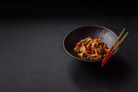 Asian food, noodles with vegetables, vegetarian dish with spicy sauce. Noodles with vegetables as a food background for your designの写真素材