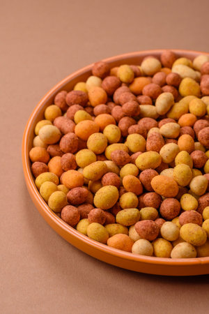 Food, nuts coated with salt and paprika, peanuts as a source of protein. Salted peanuts coated with...