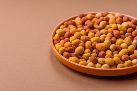Food, nuts coated with salt and paprika, peanuts as a source of protein. Salted peanuts coated with...