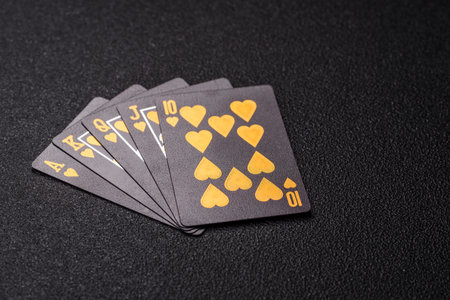 Playing card game poker in casino with chips, bets and risk. Cards and chips on black felt as...