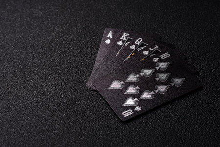 Playing card game poker with chips, bets and risk. Cards and chips on black felt as background for your designの写真素材