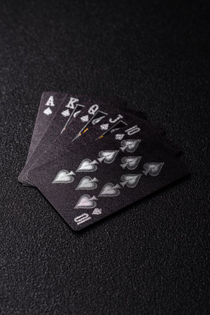 Playing card game with cards and chips on black felt as background for your design