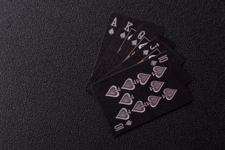 Playing card game poker with chips, bets and risk. Cards and chips on black felt as background for your designの写真素材