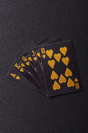 Playing card game poker with chips, bets and risk. Cards and chips on black felt as background for...