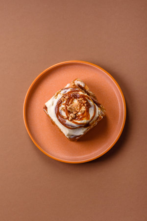 a sweet cinnamon pastry, a high calorie bun or roll. with cinnamon as a food background for your designの写真素材
