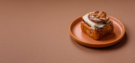 A sweet cinnamon pastry, a high calorie bun or roll. Cinnamon as a food background for your design