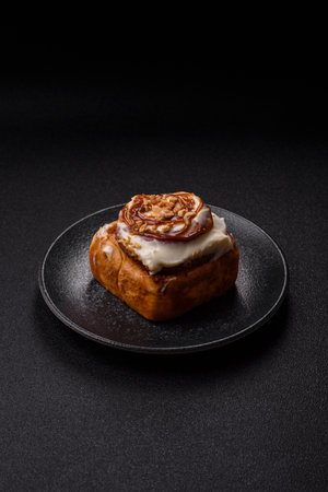 a sweet cinnamon pastry, a high calorie bun or roll. with cinnamon as a food background for your designの写真素材