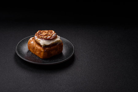 Cinnabon, a sweet cinnamon pastry, a high calorie bun or roll. Cinnabon with cinnamon as a food background for your designの写真素材