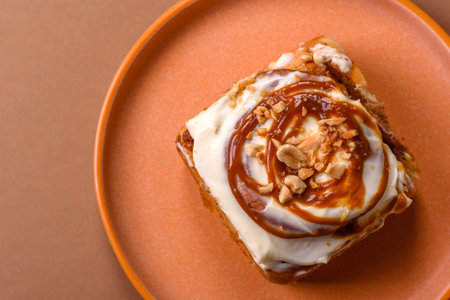 a sweet cinnamon pastry, a high calorie bun or roll. with cinnamon as a food background for your designの写真素材