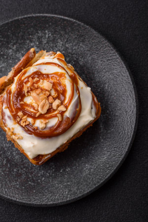 a sweet cinnamon pastry, a high calorie bun or roll. with cinnamon as a food background for your...